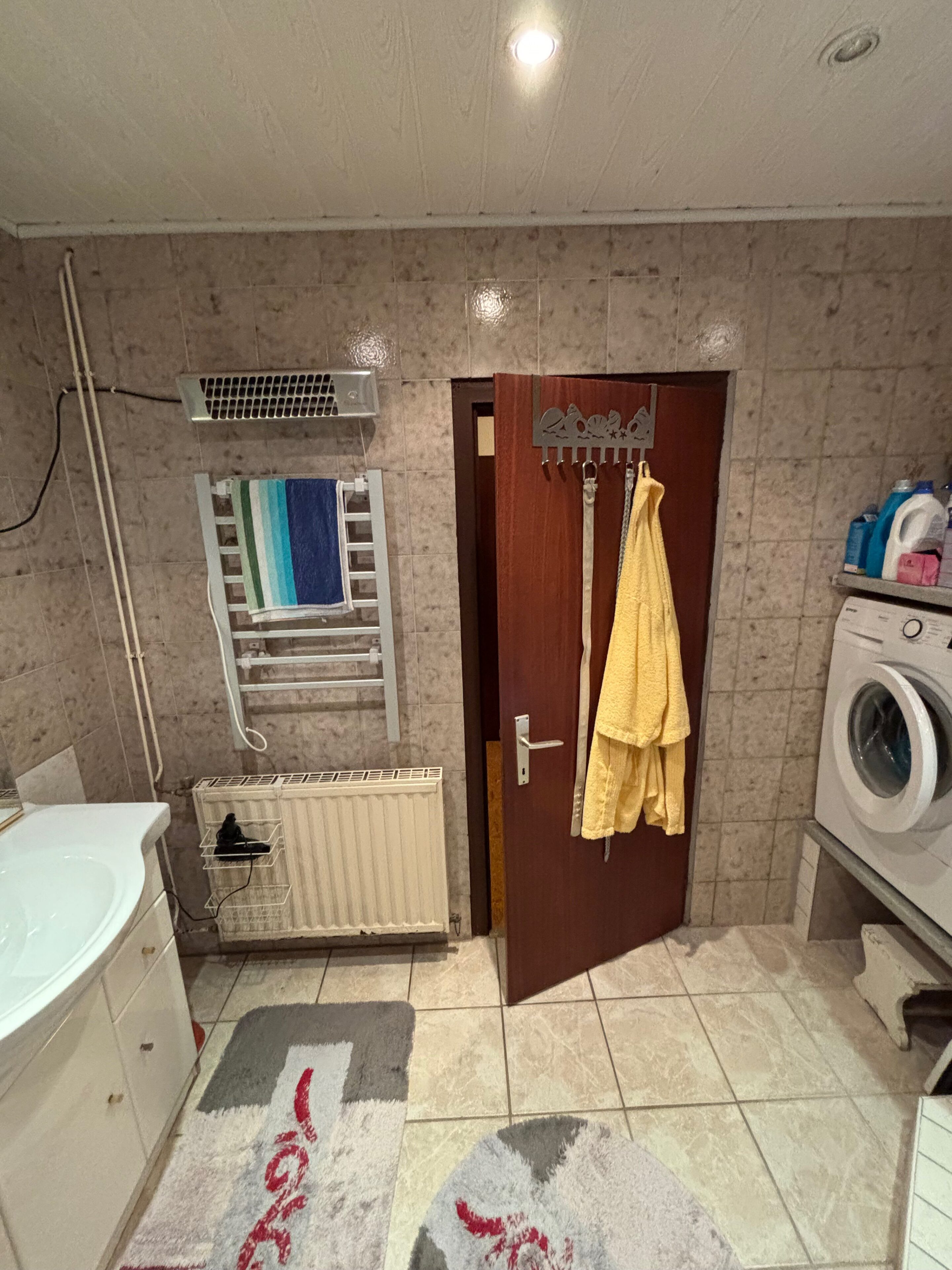 Altes Badezimmer in Kalladorf mit durchgehend gefliesten Wänden