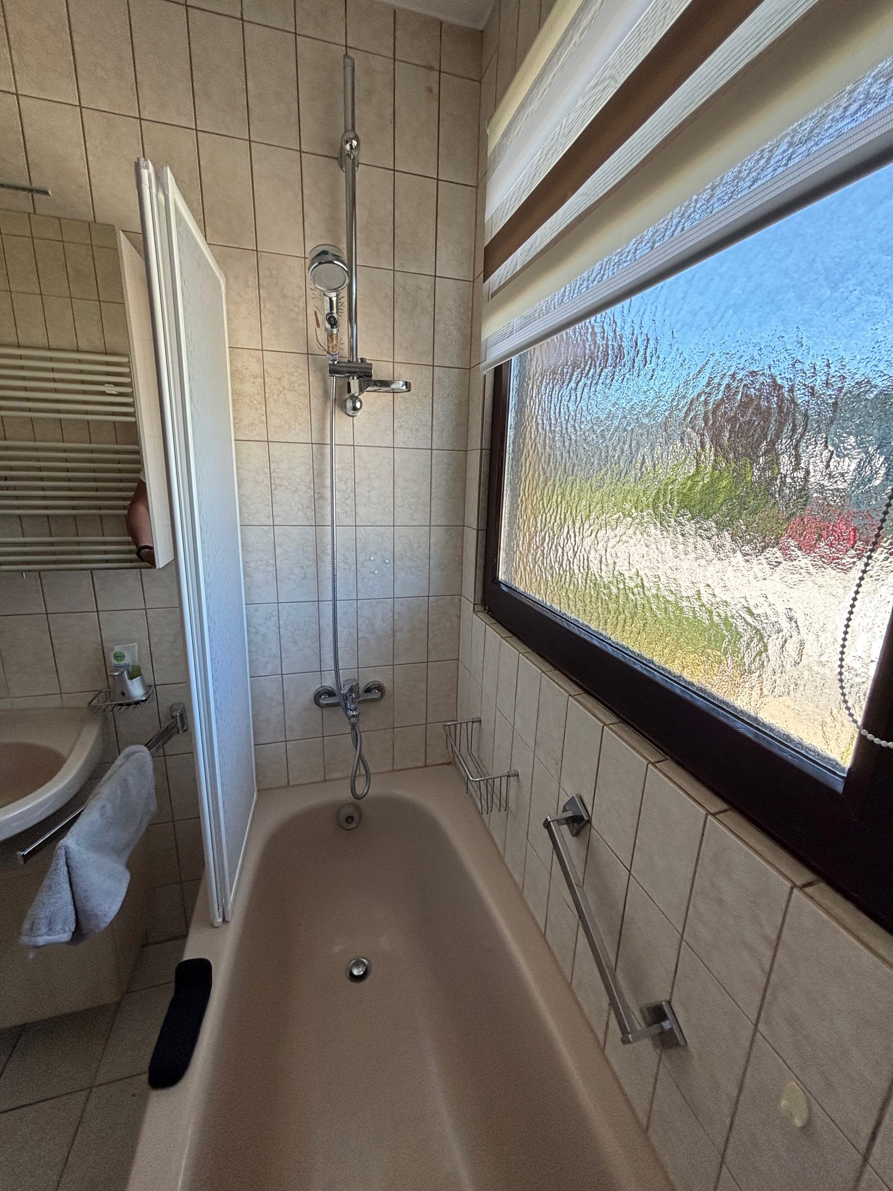 Altes Badezimmer in Eggenburg mit Badewanne und gefliesten Wänden